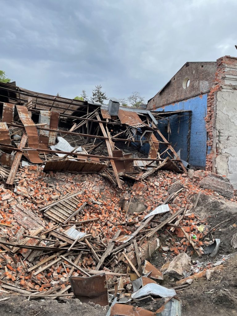 a pile of rubble next to a building